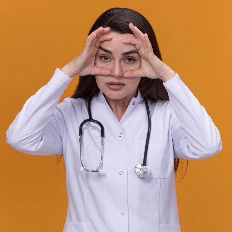 annoyed-young-female-doctor-wearing-medical-robe-with-stethoscope-puts-hands-face-isolated-orange-wall-with-copy-space-1.jpg